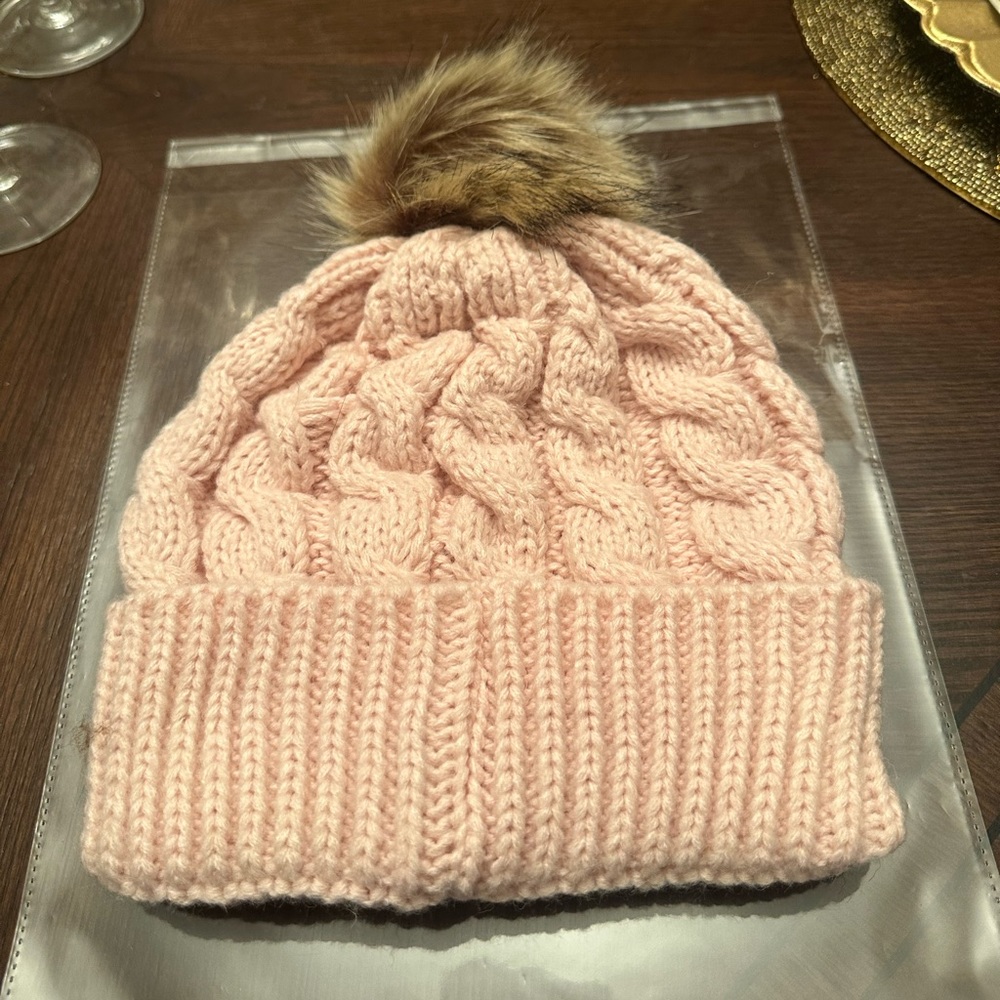 New in packaging. Women’s Light Pink Puff Beanie Perfect for the Coldness.